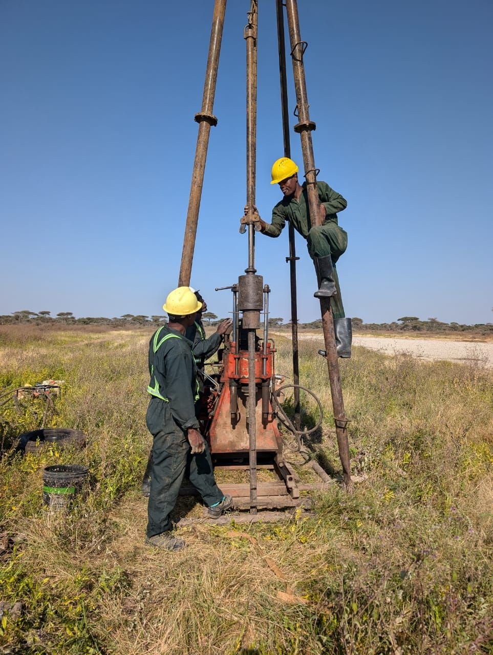Geotechnical investigation with airstrip visible in the background, Ndutu, Ngorongoro